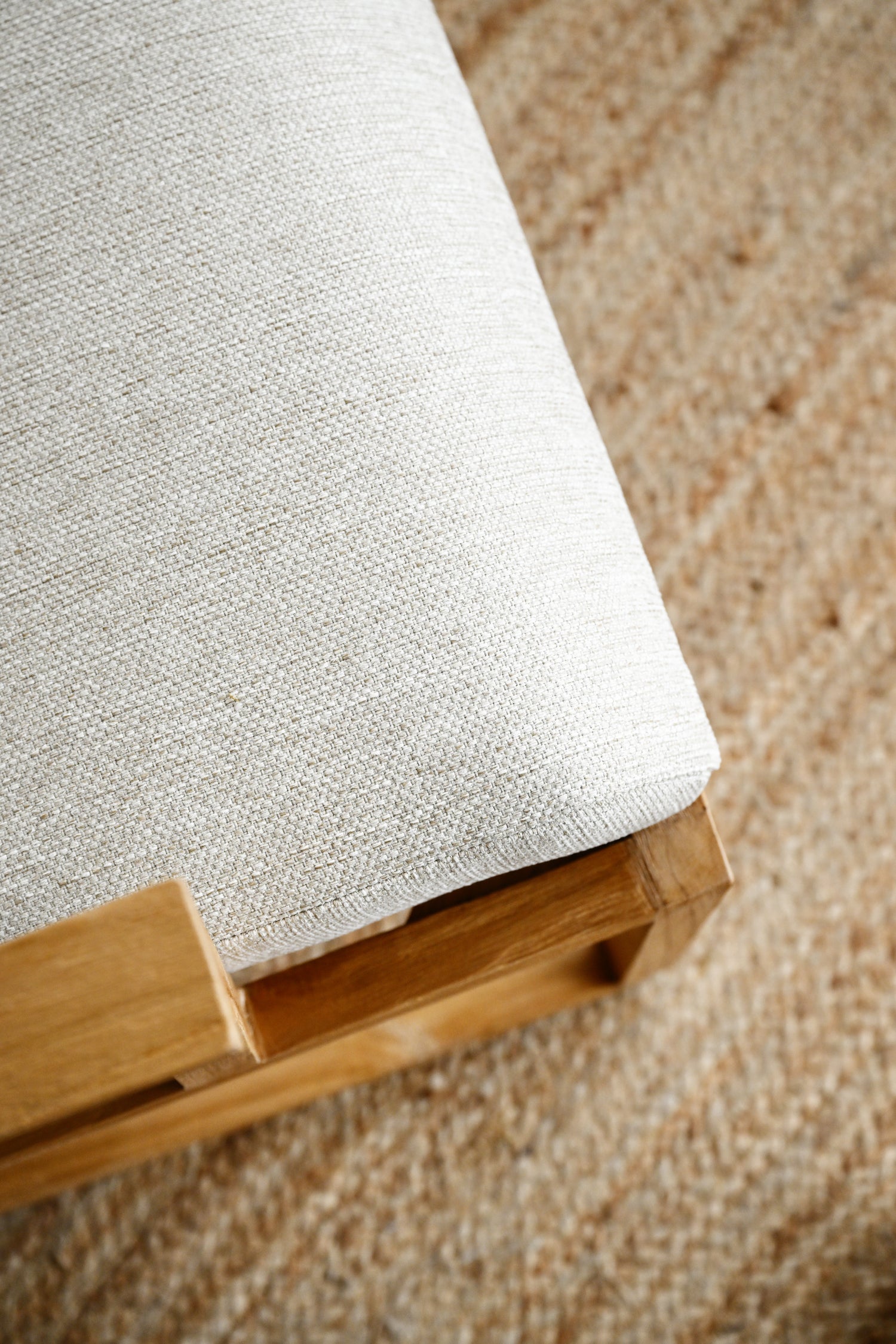 White fabric on a wooden frame against a textured brown background