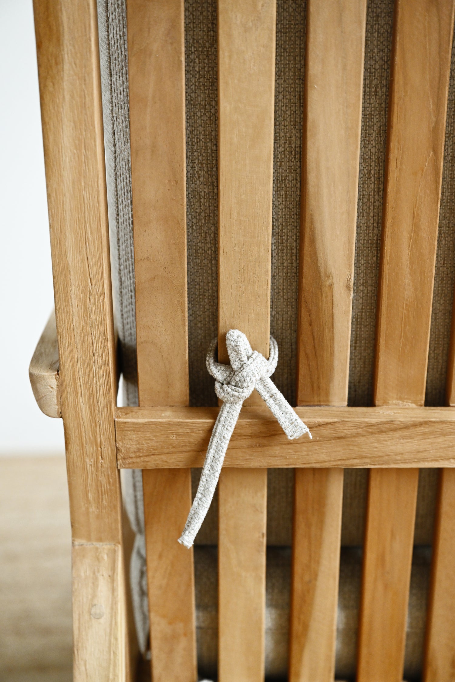 Wooden chair with a rope tied around the backrest