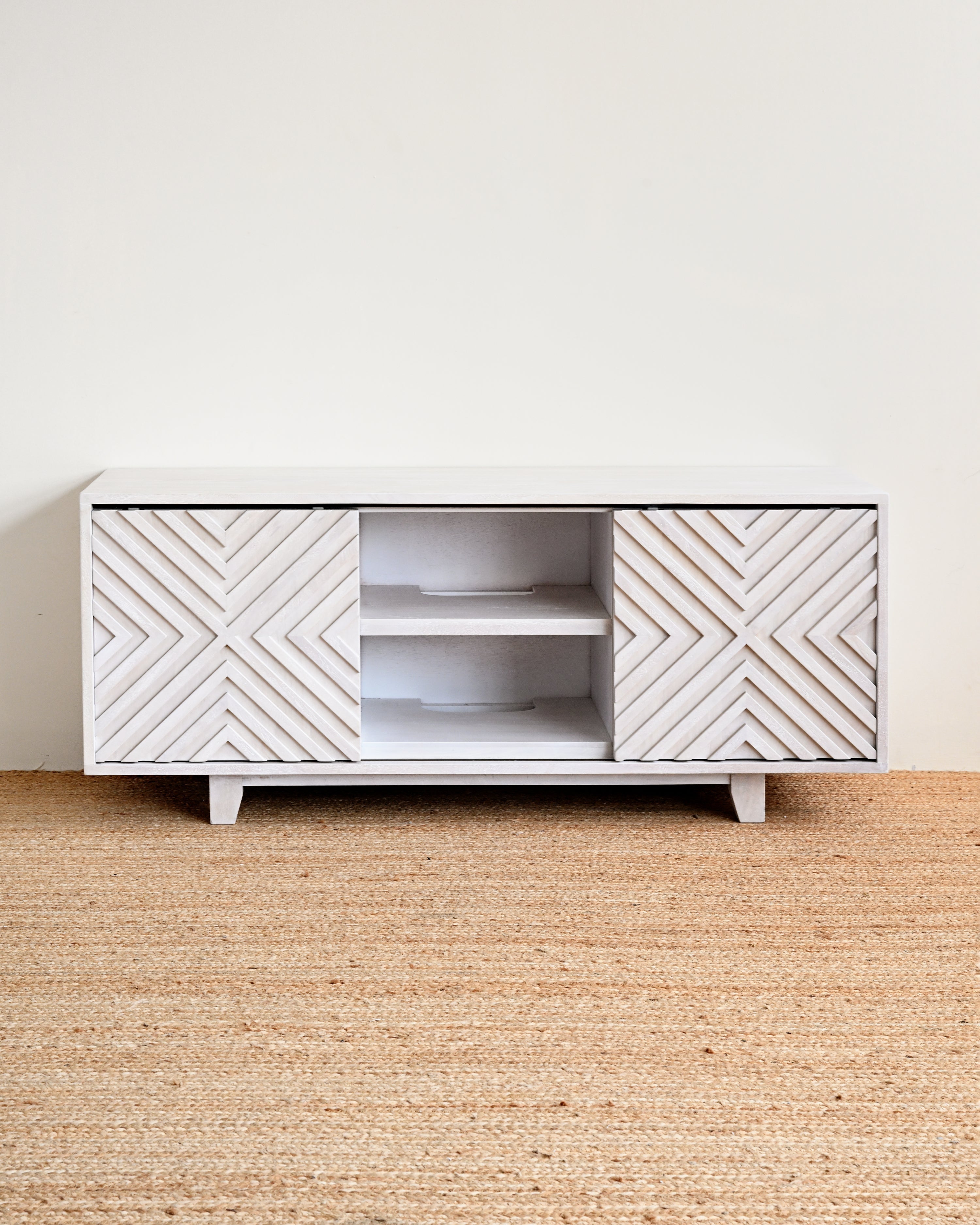 White cabinet with geometric pattern on a beige carpet and white wall