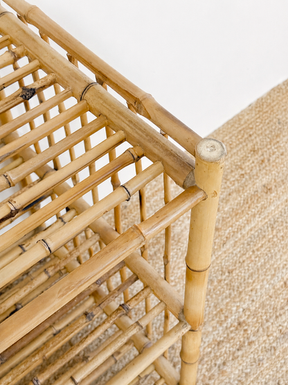 Close-up of a bamboo shelf with a textured beige background