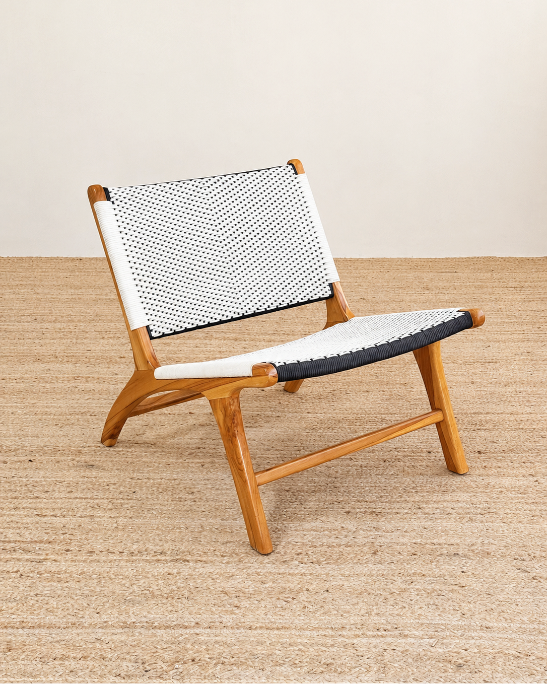 Wooden chair with a black and white patterned backrest on a beige floor.