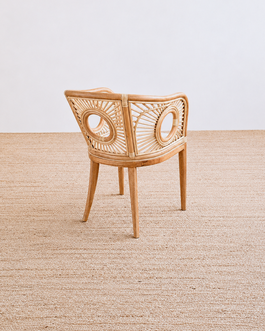 Wicker chair on a textured beige floor with a neutral background