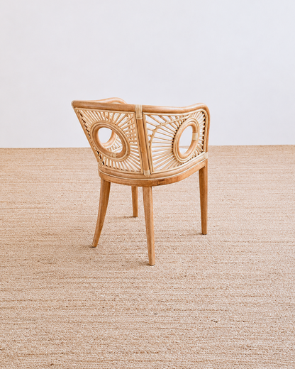 Wicker chair on a textured beige floor with a neutral background