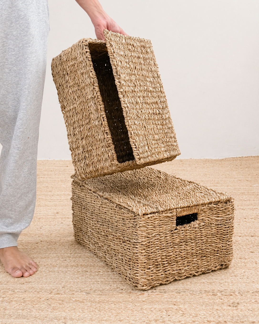 Woven storage baskets on a wooden floor with a neutral background