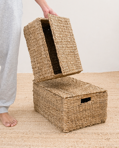 Woven storage baskets on a wooden floor with a neutral background
