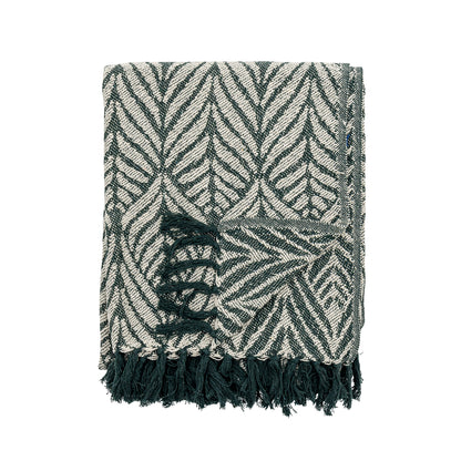 Black and white patterned throw blanket with fringes on a white background