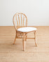 Wooden chair with a white cushion on a wooden floor.