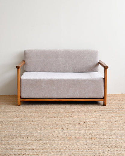 Gray sofa with wooden frame on a beige carpet