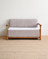 Gray sofa with wooden frame on a beige carpet