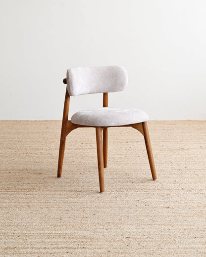 Chair with white cushioned seat and backrest on a beige carpet