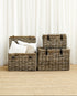 Set of wicker storage baskets with pillows against a white curtain background