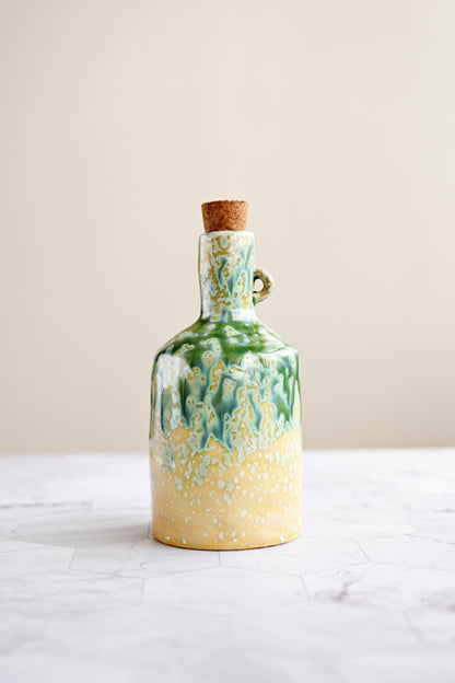 Ceramic bottle with a cork stopper on a white surface