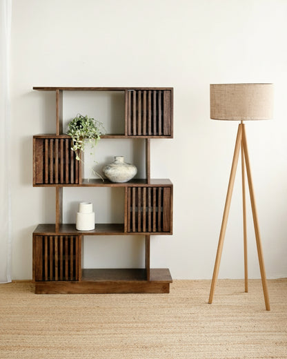 Mango wood bookshelf pictured with a standing lamp