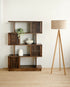 Mango wood bookshelf pictured with a standing lamp