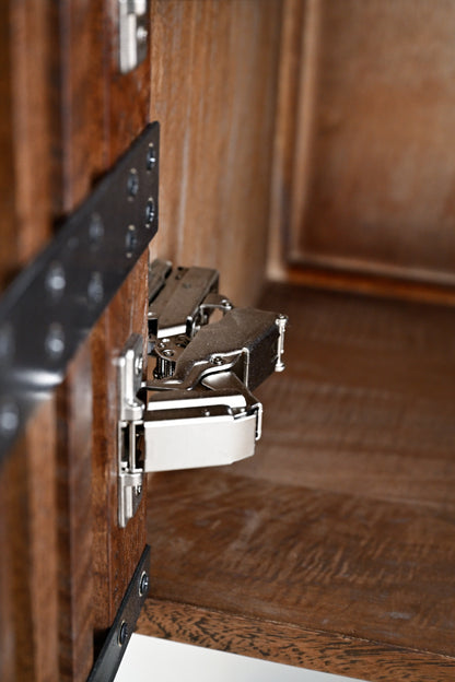 Close-up of a cabinet hinge on wooden furniture