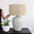 Woman holding stone table lamp by Island Living